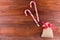 two candy canes lollipop with sack bag red ribbon bow on dark wooden board background