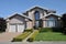 Two car garage house with decorative schrubs