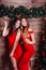 Two carefree women in red dresses dancing at New year party.