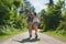 Two carefree women walking and hugging each other during a hike. Carefree friends on holiday hugging during a hike. Two