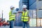Two cargo container workers or engineer men show greeting together with new normal style by touching their elbow in workplace area