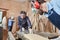 Two carpenters cutting wood