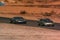 Two cars driving around race track