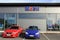 Two Cars in front of a Shop with Mobil Sign