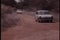 Two cars skidding off dirt road