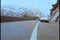 Two cars speeding through mountainside highway
