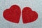 Two carved red hearts on a gray glossy background. Abstract shiny pattern. Craft paper, glitter, sparkling texture. Love concept
