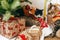 Two cats in cute reindeer costumes sitting at stylish gift boxes under christmas tree. Happy holidays