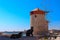 Two cats are sitting on the background of windmills - a symbol of Rhodes