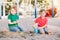 Two Caucasian children sitting in sandbox playing with beach toys. Little boys friends having fun together on a playground. Summer