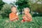 Two Caucasian funny children boys siblings sitting together eating sharing one ice-cream.