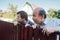 Two caucasian men carefully watching over the fence.