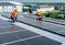 Two Caucasian technician workers sit on rooftop area to check and maintenance the solar cell panels on rooftop of factory or the