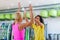 Two Caucasian women giving high five after training in gym