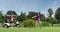 Two caucasian women playing golf one taking shot from bunker