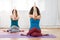 Two caucasian women practicing eagle pose in yoga class