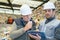 Two caucasian workers communicating in recycling center