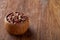 Two ceramic bowls with raw peanuts mix isolated over rustic wooden backround, top view, close-up.