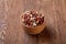 Two ceramic bowls with raw peanuts mix isolated over rustic wooden backround, top view, close-up.