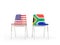 Two chairs with flags of US and south africa isolated on white
