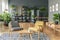 Two chairs next to a table on a patterned rug in botanic room in