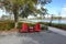 Two chairs sitting in a park by a lake in Laurete Park in Lake Nona, Orlando, FL on a beautiful sunny day