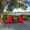 Two chairs sitting in a park by a lake in Laurete Park in Lake Nona, Orlando, FL on a beautiful sunny day