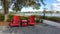 Two chairs sitting in a park by a lake in Laurete Park in Lake Nona, Orlando, FL on a beautiful sunny day