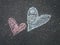 Two chalk drawn hearts on the asphalt, closeup