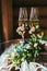 Two champagne glasses decorated with small boutonniere