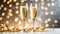 Two champagne glasses with golden confetti over illuminated background