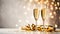 Two champagne glasses with golden confetti over illuminated background