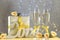 Two Champagne glasses with yellow bows standing on table with love letters, gift and roses, bokeh lights, St. Valentine or wedding