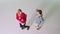 Two charismatic dancing ladies in a white large studio enjoying the time in front of the camera taking video from the