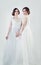 Two charming bride portrait. Perfect women in white wedding dress portrait