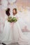 Two charming brides in beautiful spring wreaths on their heads. Beautiful young women in wedding dresses