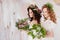 Two charming brides in beautiful spring wreaths on their heads. Beautiful young women in wedding dresses