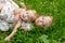 Two charming sisters blonde girl hugging and laughing, lying on