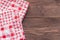 Two checkered napkins on wooden background,close up