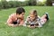 Two cheerful brothers lying on green lawn