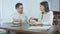 Two cheerful coworkers talking over coffee in a cafe