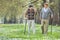 Two cheerful elderly men walking in a park