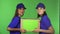 Two cheerful female delivery service workers smiling holding cardboard box