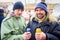 Two cheerful friends toasting with beer, outdoor