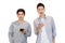 Two cheerful friends wear gray t-shirts standing isolated over white background, holding mobile phone.Couple of cool guys using