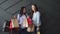 Two cheerful girlfriends holding shopping bags in their hands, black friday concept