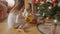 Two cheerful girls running to the gifts under Christmas tree at morning