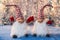 Two cheerful gnomes with hands up on silver tinsel background