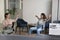 Two cheerful office worker women riding workplace chairs