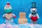 Two cheerful snowmen stand in the snow, between them there is a wooden pedestal for the inscription, valentine\\\'s day